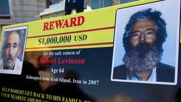 an FBI poster showing a composite image of former FBI agent Robert Levinson, right, of how he would look like after then-five years in captivity, and an image, left, taken from the video, released by his kidnappers in Washington during a news conference. (AP)