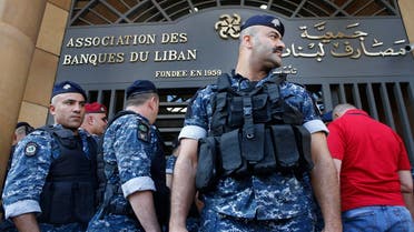 Police stand guard outside the building of the Lebanese Association of Banks after anti-government protesters locked the main entrance by a chain and lock during ongoing protests against the banks' policies and the government in Beirut, Lebanon, Friday, Nov. 1, 2019. (AP)