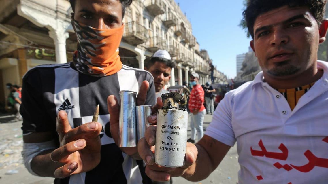 Iraqi protesters show bullets and tear gas canisters during clashes with security forces in the capital Baghdad. (AFP)