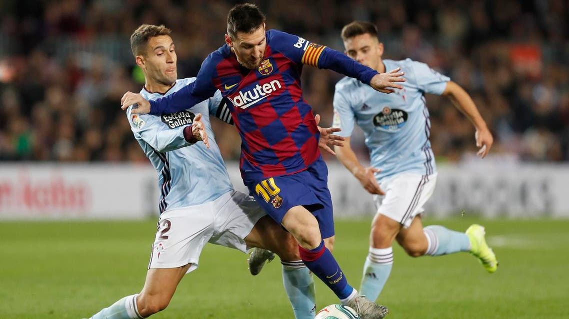 Lionel Messi, center, and Celta Vigo's Hugo Mallo, left, vie for the ball during a Spanish La Liga soccer match between Barcelona and Celta at Camp Nou stadium in Barcelona, Saturday, Nov. 9, 2019. (AP)