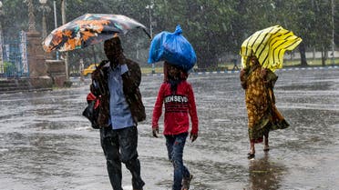 Indians walk in the rain in Kolkata, India, Saturday, Nov. 9, 2019. (AP)