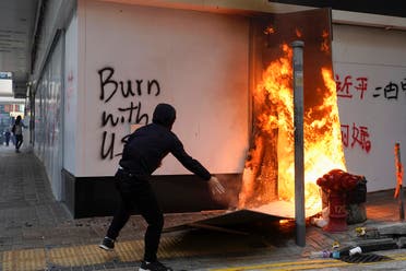 A protester sets fire to the cardboards outside the Bank of China branch during a protest in the Central district of Hong Kong. (File photo:  AFP)