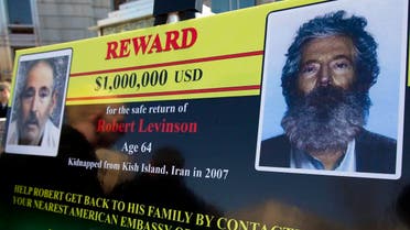 In this March 6, 2012 file photo, an FBI poster showing a composite image of former FBI agent Robert Levinson, right, of how he would look like now after five years in captivity. (AP)