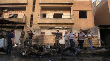 People gather after a car bomb exploded in the town of Qamishli, Syria, Friday, Oct. 11, 2019.  (AP)