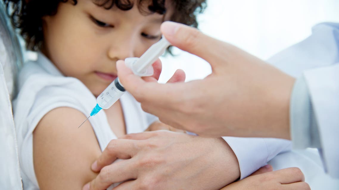 Young boy getting a vaccine stock photo
