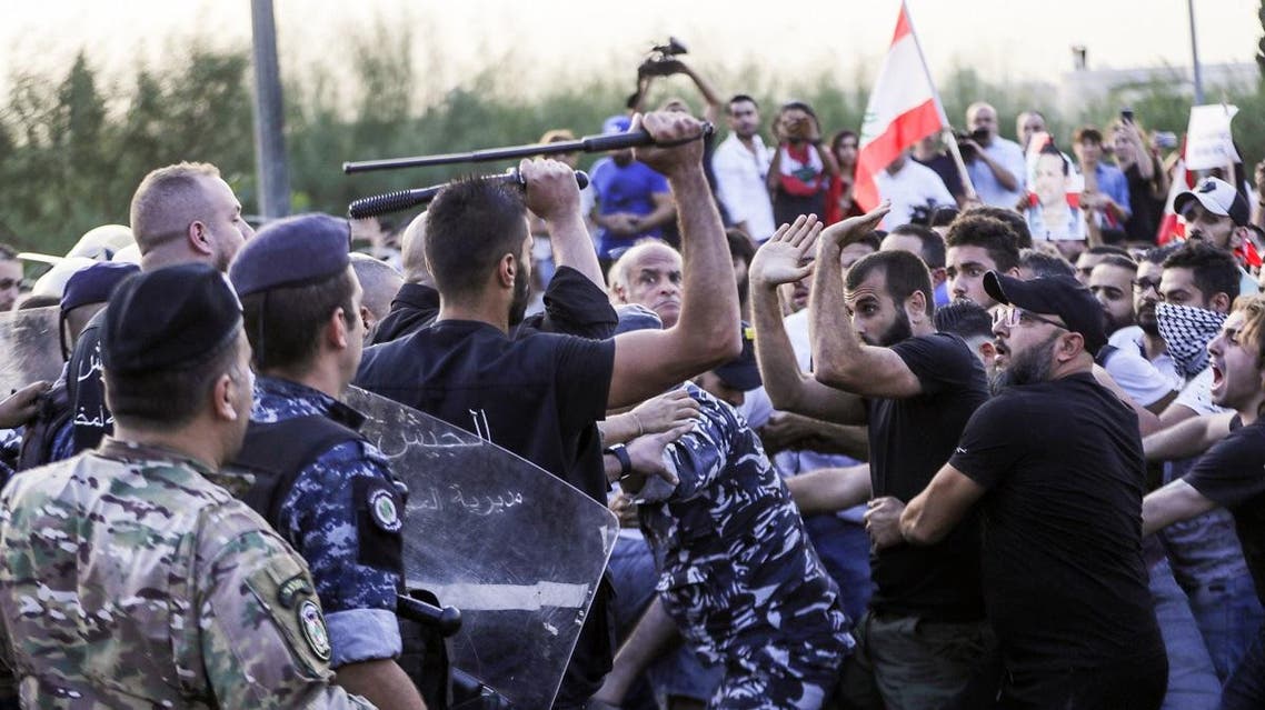 Lebanese demonstrators clash with anti-riot police on the road leading to the Presidential Palace in Baabda, on the eastern outskirts of Beirut on November 13, 2019. (AFP)