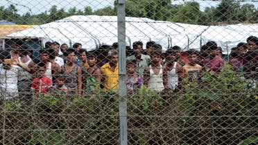 In this June 29, 2018, photo, Rohingya refugees gather near a fence during a government organized media tour, to a no-man's land between Myanmar and Bangladesh, near Taungpyolatyar village, Maung Daw, northern Rakhine State, Myanmar. (AP)