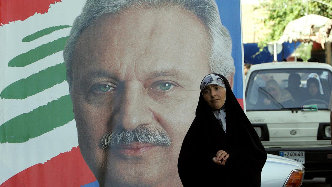 Lebanese woman walks past election poster of Mohammed Safadi back in 2009 - AFP