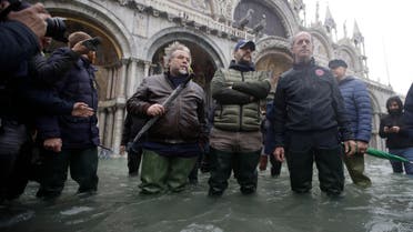 The League leader Matteo Salvini, center, stands in a flooded St. Mark's Square in Venice, Italy, Friday, Nov. 15, 2019. (AP)