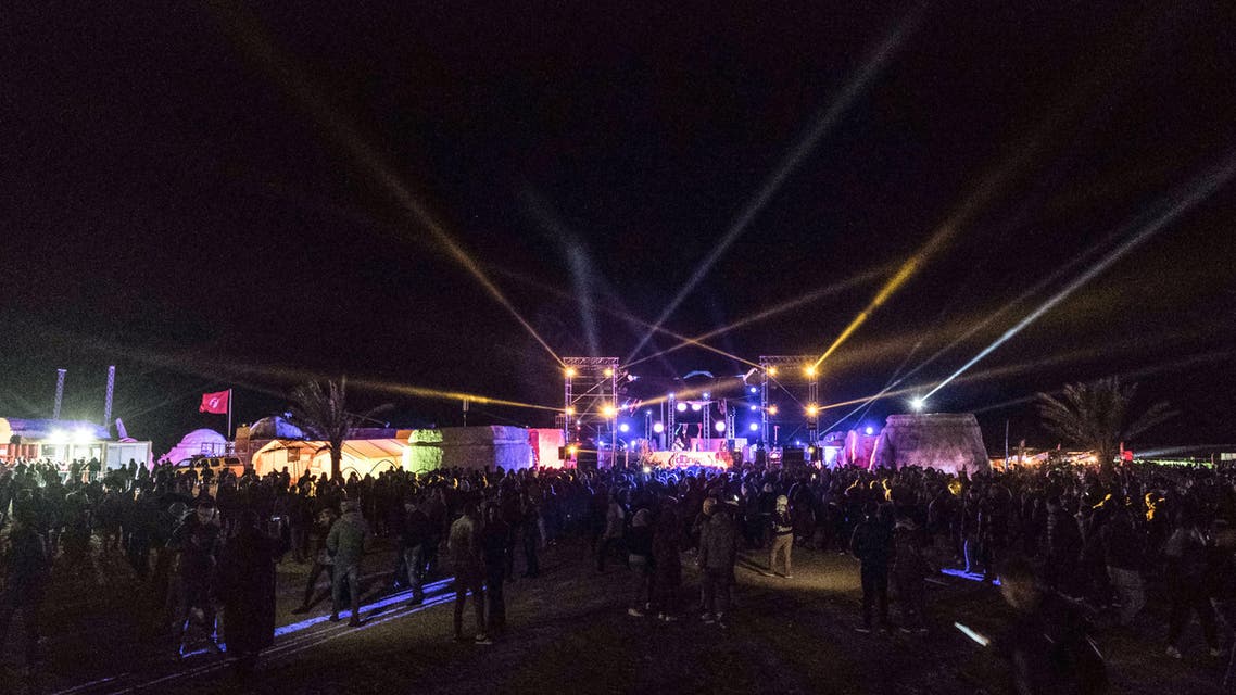 People dance at the electronic music festival "Les Dunes Electroniques" at Ong Jmel, near the town of Nefta in western Tunisia on November 16, 2019, where the original Star Wars film was shot. (AFP)