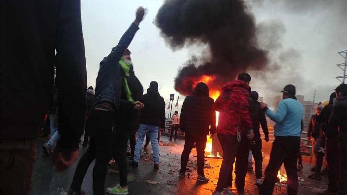 Iranian protesters gather around a fire during a demonstration against an increase in gasoline prices in the capital Tehran. (AFP)