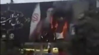 Iran protesters set fire to Khamenei billboard as security crackdown intensifies