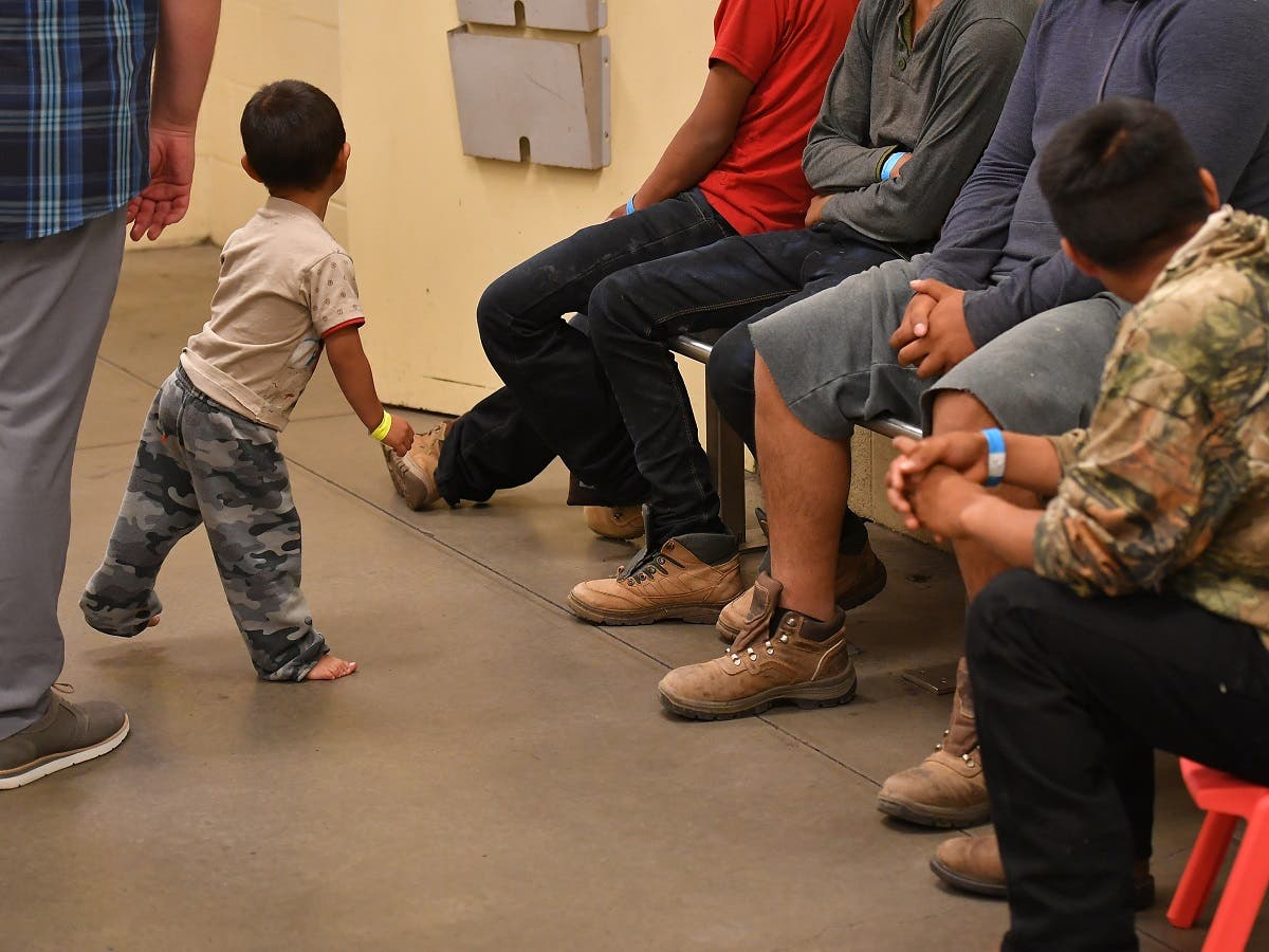 Young migrant children, whose faces can not be shown, are seen at the US Customs and Border Protection Facility in Tucson, Arizona June 28, 2018. (AFP)