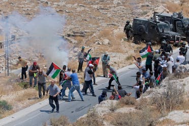 Israeli border police block the road and disperse Palestinian, Israeli and foreign activists during a rally protesting a newly established settlement near the West Bank village of Kufr Malik on Aug. 16. 2019. (AP)