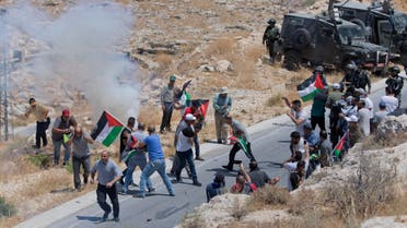 Israeli border police block the road and disperse Palestinian, Israeli and foreign activists during a rally protesting a newly established settlement near the West Bank village of Kufr Malik, East of Ramallah, Friday, Aug. 16. 2019. (AP Photo/Nasser Nasser)