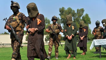 Afghan security personnel escort arrested alleged Taliban and ISIS militants during an operation in Jalalabad province on October 1, 2019. (AFP)