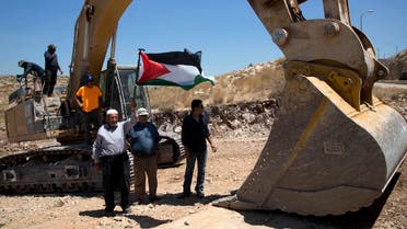 Palestinians demonstrated Wednesday in front of Israeli bulldozers that were bulldozing land outside Deir Qaddis village near Ramallah for an apparent plan to expand a nearby Jewish settlement. (AP)