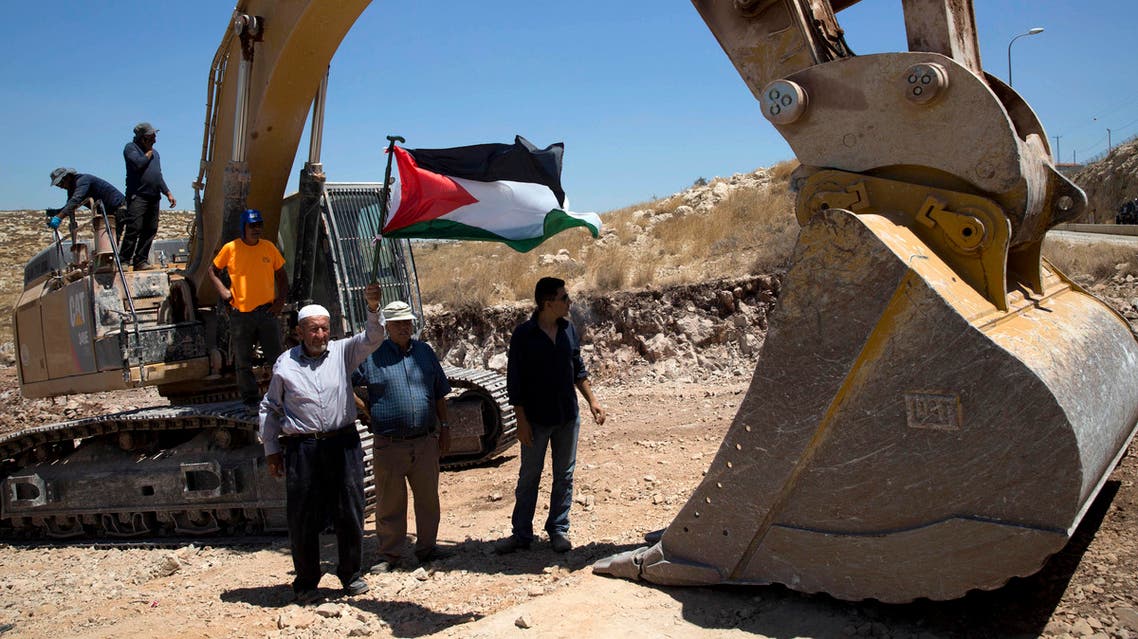 Palestinians demonstrated Wednesday in front of Israeli bulldozers that were bulldozing land outside Deir Qaddis village near Ramallah for an apparent plan to expand a nearby Jewish settlement. (AP)