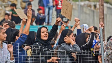 Refugees and migrants take part in a protest outside an overcrowded refugee camp on the Greek island of Samos, on Friday, Oct. 18, 2019. (AP)