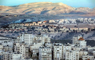 This picture taken on November 17, 2018 from East Jerusalem shows a view of the Israeli settlement of Maale Adumim (C) with the East Jerusalem Arab-inhabited Shuafat refugee camp. (AFP)