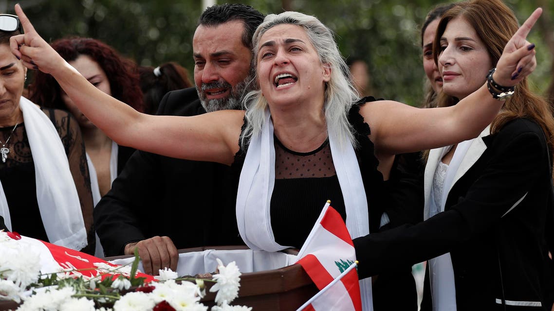 Alaa Abou Fakher's wife Lara mourns him at his funeral on November 14, 2019. (AP)