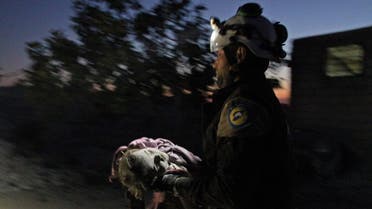 A member of the Syrian Civil Defense (White Helmets) carries a young victim following a reported Russian airstrike on the town of Maaret al-Numan in Syria's northwestern Idlib province on November 20, 2019. (AFP)