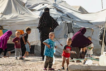 Women look after children at the Kurdish-run al-Hol camp for the displaced where families of ISIS foreign fighters are held, in the al-Hasakeh governorate in northeastern Syria, on October 17, 2019. (AFP)