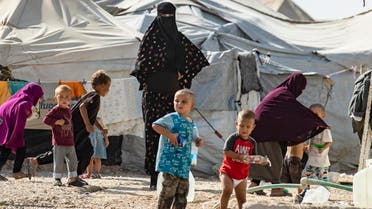 Women look after children at the Kurdish-run al-Hol camp for the displaced where families of ISIS foreign fighters are held, in the al-Hasakeh governorate in northeastern Syria, on October 17, 2019. (AFP)