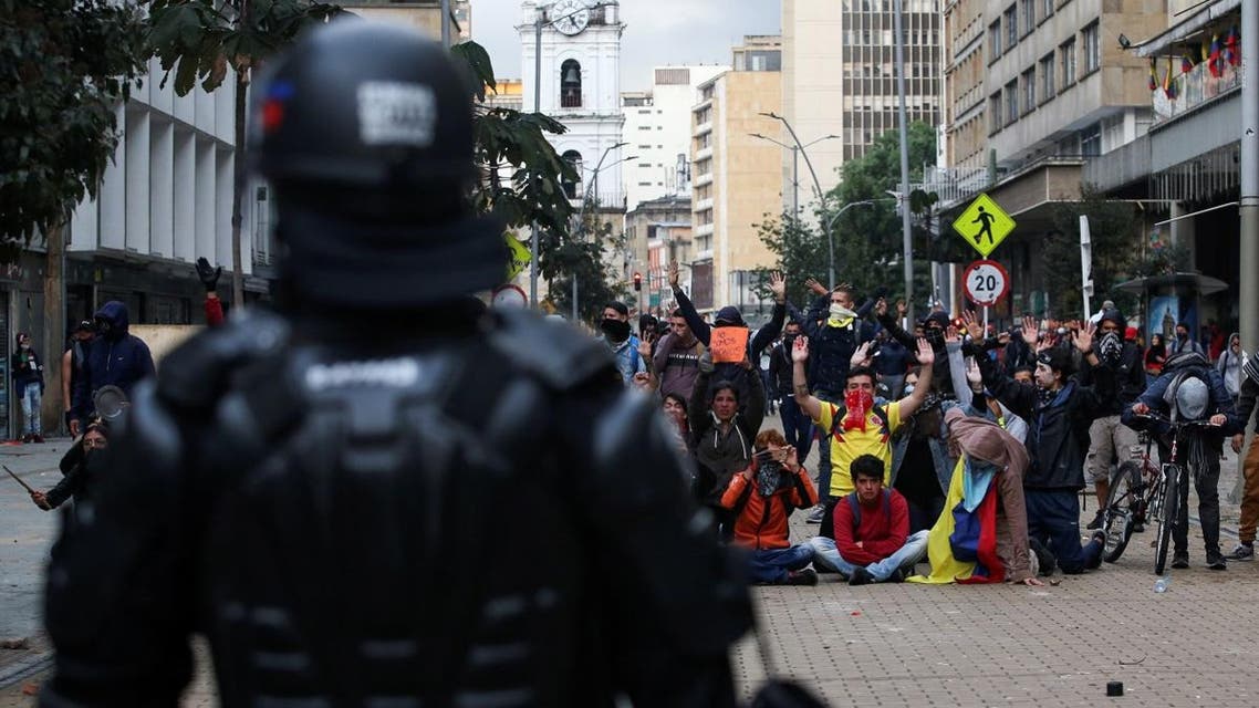 Demonstrators gesture in front of a member of riot police during a protest on the second day of a national strike, in Bogota, Colombia, on November 22, 2019. (Reuters)