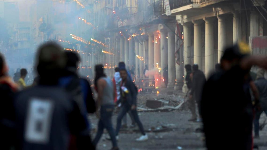 Riot police fire tear gas during clashes with anti-government demonstrators in Baghdad, Iraq, Saturday, Nov. 23, 2019. (AP)