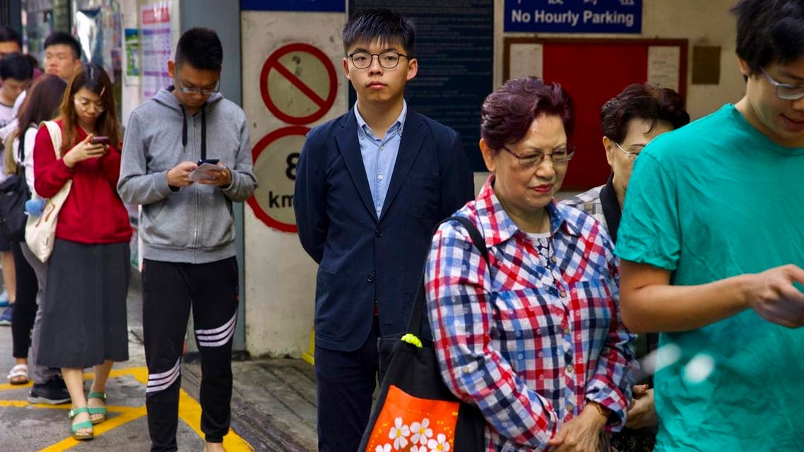 Pro-democracy activist Joshua Wong, center, stands in line to vote outside of a polling place in Hong Kong, Sunday, Nov. 24, 2019. (AP)
