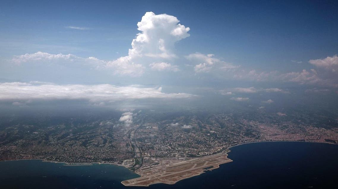 This picture taken on July 21, 2019 shows an aerial view of the French riviera city of Nice (R) and the Nice International Airport (Aeroport de Nice Cote d'Azur)(L) in Nice, southeastern France. (AFP)