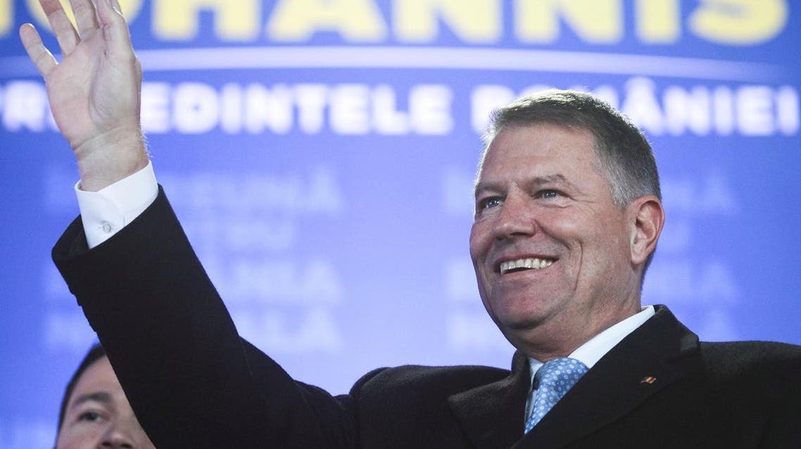 Incumbent candidate Klaus Iohannis reacts after receiving the first exit poll results following the second round of a presidential election in Bucharest, Romania, November 24, 2019. (Reuters)