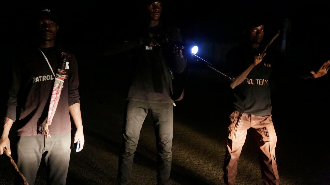 In this photo taken on Thursday, Feb. 21, 2019, vigilantes armed with a weapons stands on a street in Yola, Nigeria. (AP)