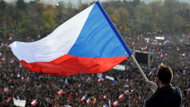 A man waves the Czech flag as demonstrators attend an anti-government rally  in Prague, November 16.jpg