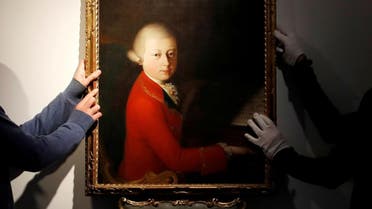 Workers install a portrait due to be sold at auction by Christie’s on November 27 which depicts composer Wolfgang Amadeus Mozart as a teenager, painted in January 1770, and attributed to Veronese master Gaimbettino Cignaroli, in Paris. (Reuters)