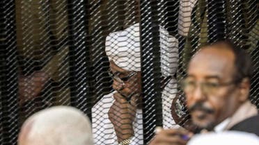 Sudan's former President Omar al-Bashir sits in a cage during his trial on corruption and money laundering charges. (File photo: AP)