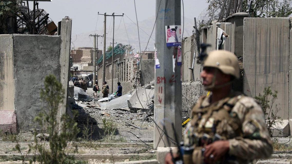 An Afghan security personnel stands guard at the site where a Taliban car bomb detonated at the entrance of a police station in Kabul on August 7, 2019. (AFP)