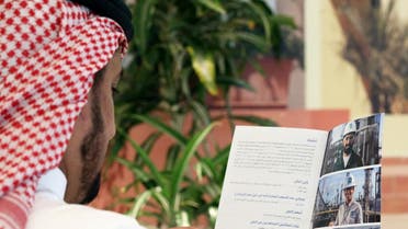 A Saudi man reads the prospectus of Aramco IPO, in Riyadh, Saudi Arabia, November 17, 2019. (Reuters)