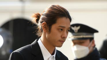 K-pop star Jung Joon-young (C) arrives for questioning at the Seoul Metropolitan Police Agency in Seoul on March 14, 2019. AFP