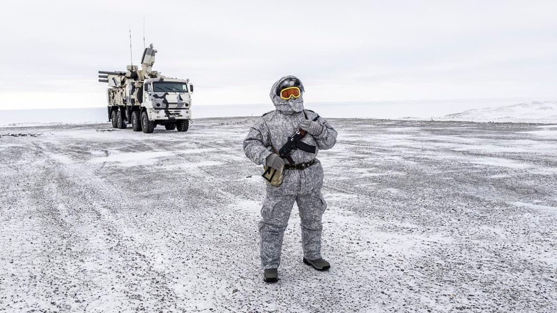 A soldier holds a machine gun as he patrols the Russian northern military base on Kotelny island, beyond the Artic circle on April 3, 2019. (AFP)