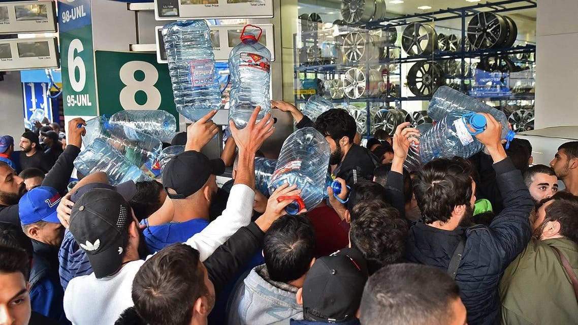 Lebanese people queue in front of a petrol station in Beirut's Cola district on November 29, 2019, following an open strike called for by the Syndicate of Fuel Station Owners. (AFP)