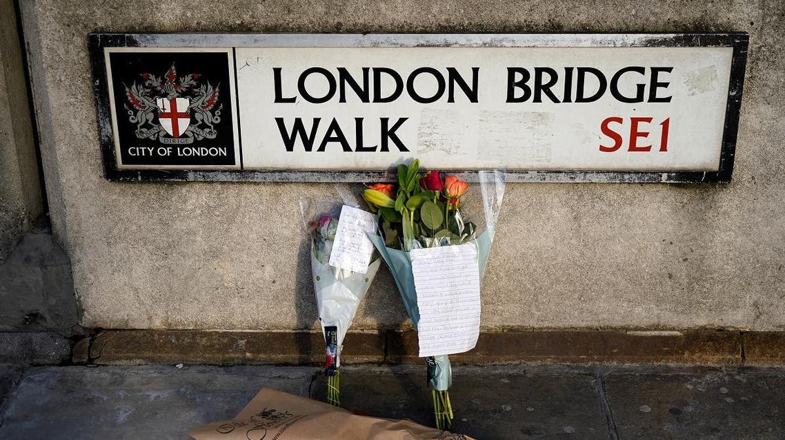 Floral tributes are pictured close to London Bridge in the City of London, on November 30, 2019, following the November 29 terror incident in which two people died after being stabbed on the bridge. (AFP)