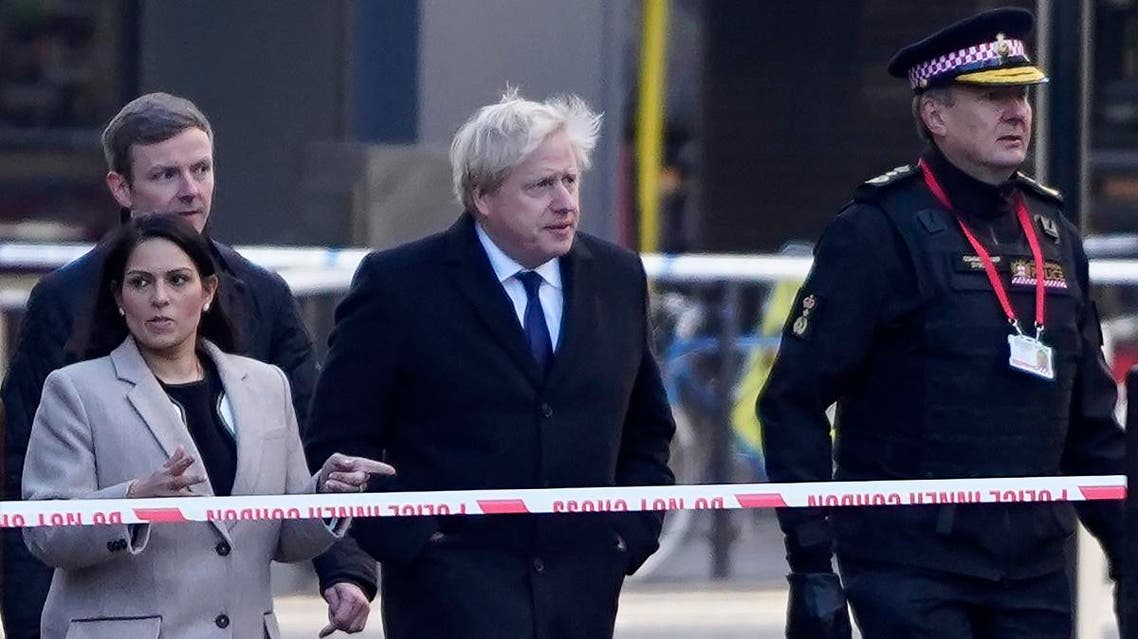 Britain's Prime Minister Boris Johnson, (c), Britain's Home Secretary Priti Patel, (L) and Commissioner of the City of London Police, Ian Dyson (R) arrive at the scene of a stabbing on London Bridge in the City of London, on November 30, 2019. (AFP)