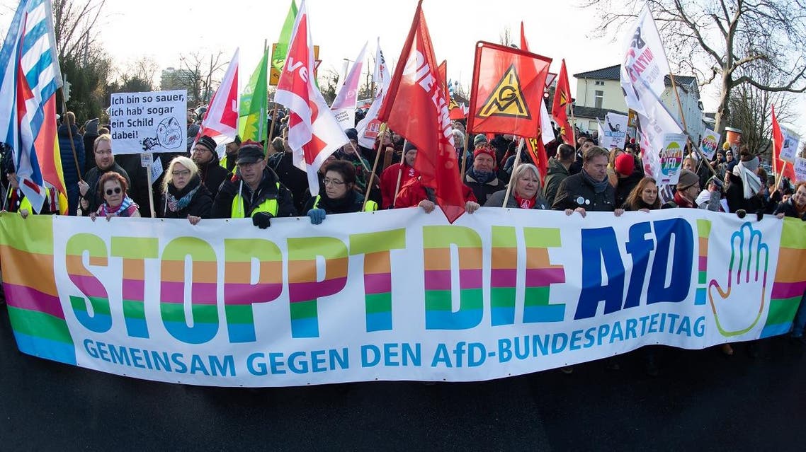 People march through the city center of Braunschweig, in north-central Germany, with a banner reading "Stop the AfD", on November 30, 2019. (AFP)