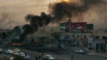Smoke billows from burning tires during a demonstration in Nasiriyah, the capital of Iraq's southern province of Dhi Qar on November 25, 2019, as protesters cut-off roads and activists call for a general strike. (AFP)