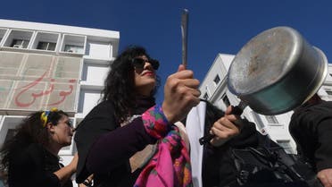 A Tunisian woman, member of the Tunisian "EnaZeda", (me too in the Tunisian dialect and inspired by the original Metoo movement) bangs a pot as she takes part in a rally against sexual harrasment, in the capital Tunis. (AFP)