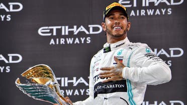 Mercedes' British driver Lewis Hamilton celebrates his win at the Yas Marina Circuit in Abu Dhabi, after the final race of the Formula One Grand Prix season, on December 1, 2019. (AFP)