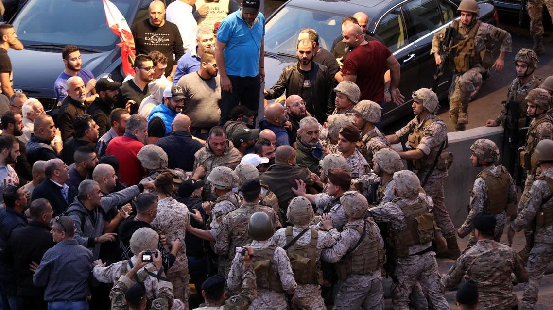 Backers of the Free Patriotic Movement founded by the Lebanese president scaffle with soldiers during a rally in his support on a road leading to the presidential palace in Baabda near the capital Beiruton December 1, 2019. (AFP)