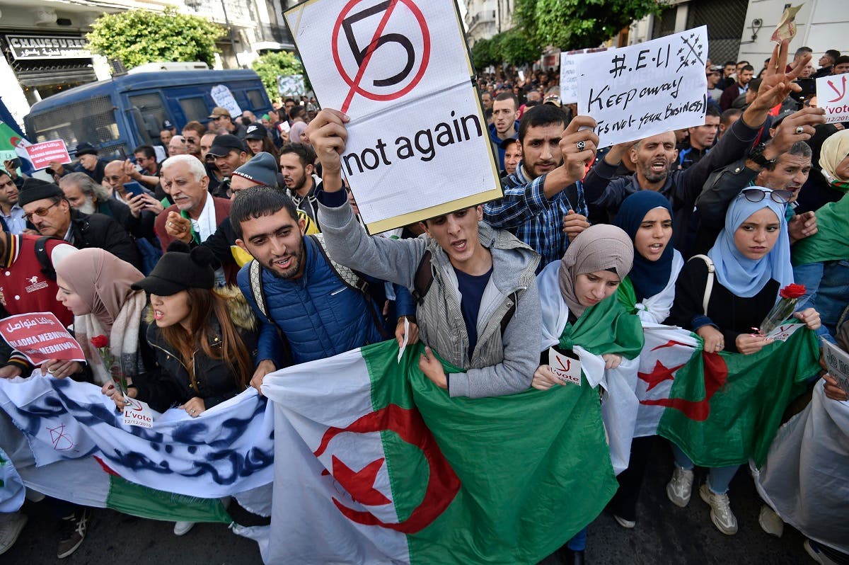Algerian demonstrators chant slogans against the upcoming presidential election as they carry national flags during an anti-government protest in the center of the capital Algiers on November 26, 2019. (AFP)